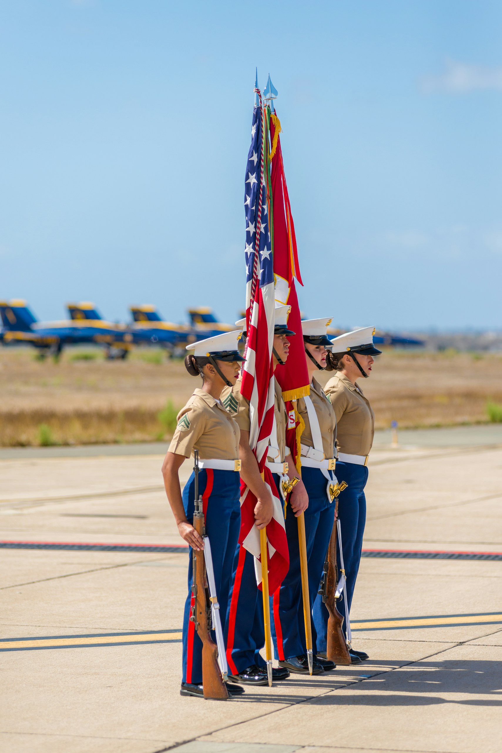Color guard awaiting forward march with Navy Blue Angels in the background.